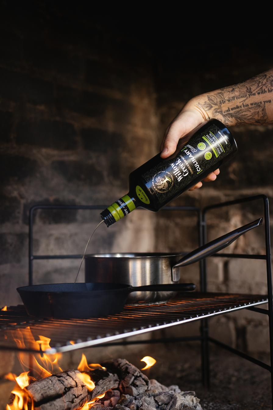 Olive oil poured over an open fire