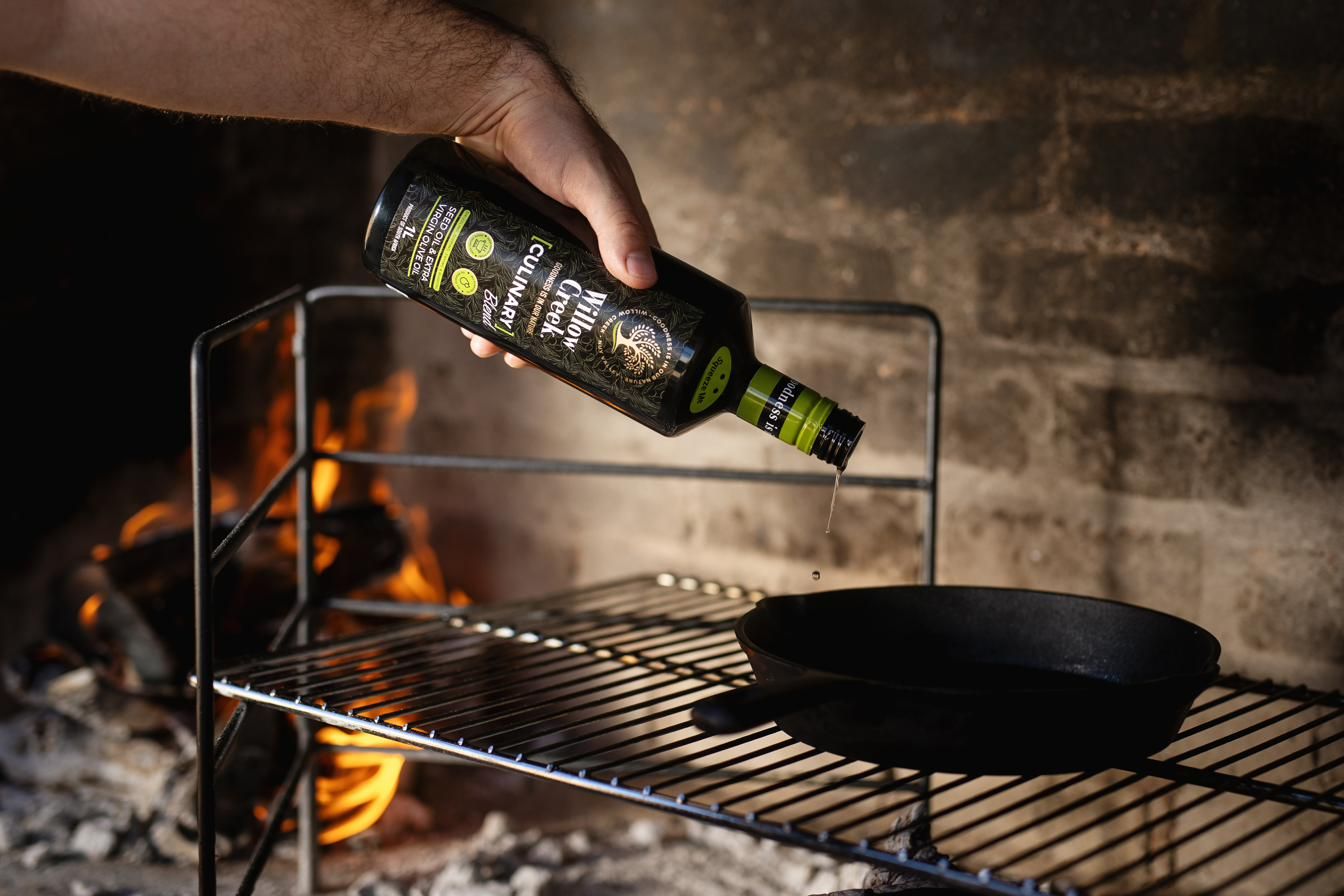 Cinematic shot of olive oil poured over a flame